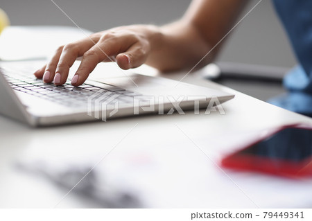 Female hands typing on the laptop keyboard at workplace Female hands typing on the laptop keyboard at workplace 79449341
