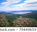 A large stone on the background of mountains with trees 79449659