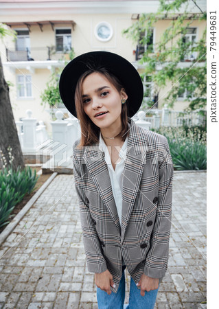 beautiful fashionable woman in black hat with fields 79449681