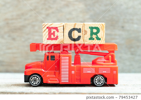 Fire ladder truck hold letter block in word ECR (Abbreviation of Efficient Consumer Response, Early Career Researcher, Engine control room) on wood background 79453427