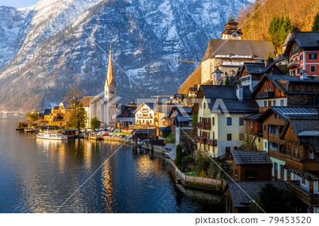 VIew of beautiful Hallstatt lake and famous church during morning sunrise in early spring VIew of beautiful Hallstatt lake and famous church during morning sunrise in early spring 79453520