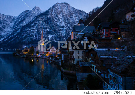 VIew of beautiful Hallstatt lake and famous church during late evening after sunset in early spring with mountain ranges VIew of beautiful Hallstatt lake and famous church during late evening after sunset in early spring with mountain ranges 79453526
