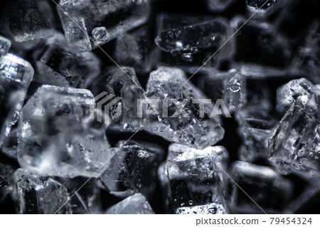 Crystal sugar close up on black background under the light microscope, magnification of 40 times, microscope objective 4 79454324