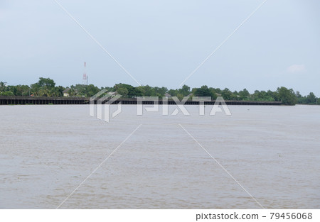 Long concrete embankment along the large river to protect the bank erosion. Long concrete embankment along the large river to protect the bank erosion. 79456068