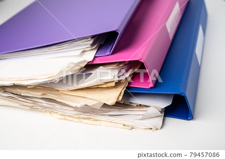 File Folder Binder stack of multi color on table in office. File Folder Binder stack of multi color on table in office. 79457086