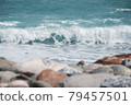 Blue-green waves rolling on the seashore 79457501