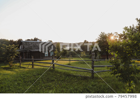 wooden european house in a picturesque countryside at sunset in summer wooden european house in a picturesque countryside at sunset in summer 79457998