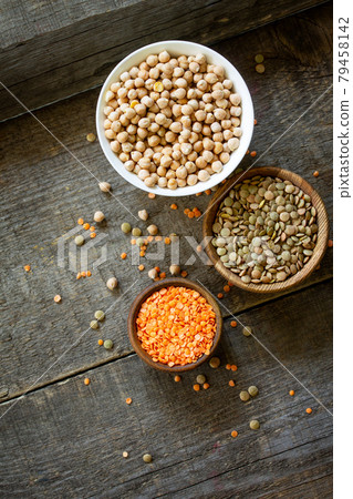 Healthy food, dieting, nutrition concept, vegan protein source. Raw legumes - red lentils and canadian lentils on wooden table. 79458142