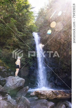 Adult Woman hiker at Norvan Falls and river stream in the natural canyon Adult Woman hiker at Norvan Falls and river stream in the natural canyon 79459014