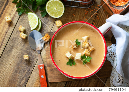 Indian food, authentic indian dish. Traditional Indian spicy lentils cream soup with spices on a rustic wooden table. Top view flat lay background. Copy space. 79461104