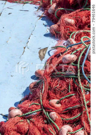 pile of red fishing nets on blue wooden background with copy space pile of red fishing nets on blue wooden background with copy space 79461646