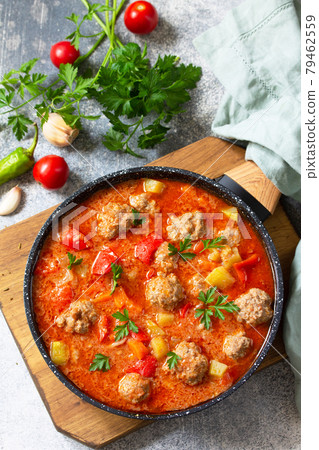 Spanish and Mexican food - Albondigas. Hot stew tomato soup with meatballs and vegetables. Top view on a flat lay. 79462559