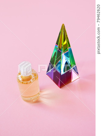 Hydrophilic cleanser oil mockup and glass pyramid prism on pink background with copy space, vertical. Makeup remover cosmetic product trendy minimalism Hydrophilic cleanser oil mockup and glass pyramid prism on pink background with copy space, vertical. Makeup remover cosmetic product trendy minimalism 79462620