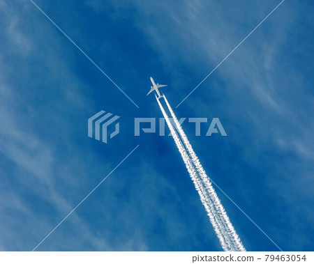 Huge passenger plane, Airbus or Boeing flying in high altitude over Old Town Square, Prague in Czech Republic, Central Europe. 79463054