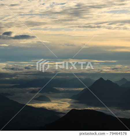 Sunrise view from Mount Brienzer Rothorn. Mount Stanserhorn and sea of fog on a cloudy summer morning. 79464576