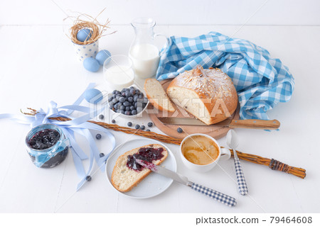 Easter breakfast or brunch table in blue style, embellished with Easter symbols, traditional Czech Easter pastry Mazanec, Pomlazka and eggs. Easter breakfast or brunch table in blue style, embellished with Easter symbols, traditional Czech Easter pastry Mazanec, Pomlazka and eggs. 79464608