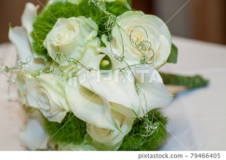 Close view on calla flowers with wedding rings in warm colors Close view on calla flowers with wedding rings in warm colors 79466405