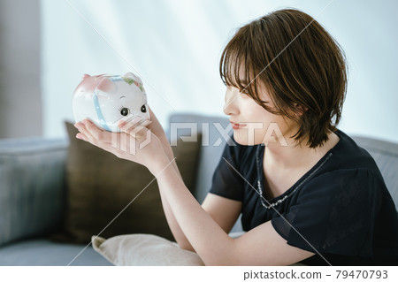 Piggy bank and young lady Piggy bank and young lady 79470793