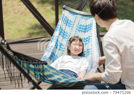 Girl experiencing a glamping hammock Girl experiencing a glamping hammock 79471206