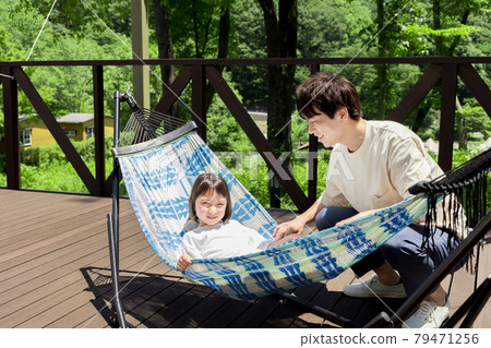 Girl experiencing a glamping hammock 79471256