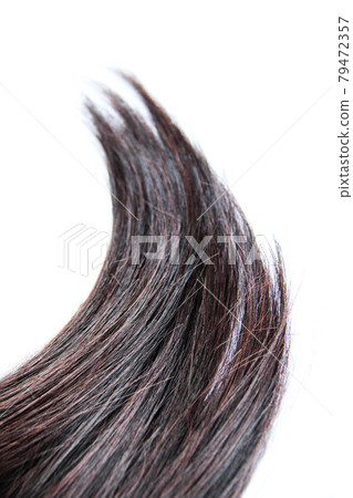 Black dark hair isolated on white background. Brunette natural hair extension on white background Black dark hair isolated on white background. Brunette natural hair extension on white background 79472357