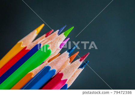 Black chalkboard background with colorful wooden pencils. Back to school concept Black chalkboard background with colorful wooden pencils. Back to school concept 79472386
