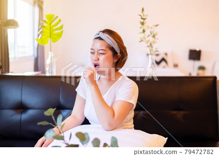 Asian woman coughing with sore throat,Women suffering with cough a lot at home 79472782
