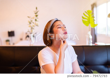 Asian woman having bone stuck in throat,Sore throat 79472783