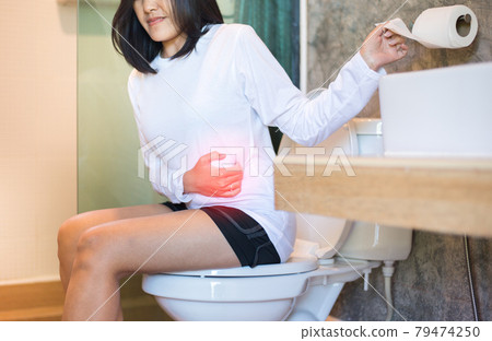 Asian woman suffering with Hemorrhoids or constipation in toilet,Female need to use the toilet in the morning 79474250