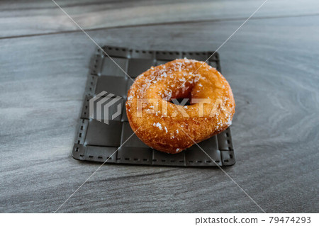 Sweet sugar donut on a wooden background 79474293
