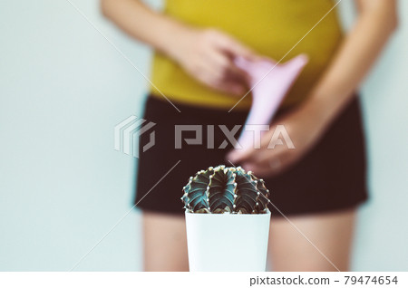 Blurred woman standing on white background with cactus and suffering from hemorrhoids,Need to pee 79474654