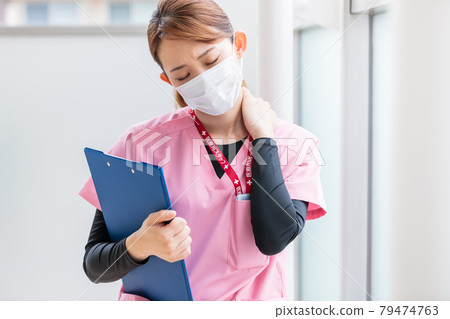 Young nurse tired of work 79474763