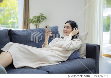A woman lying down in the living room 79476985