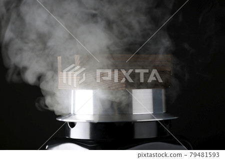 A picture of rice being cooked in a one-go cooking pot on a black background 79481593