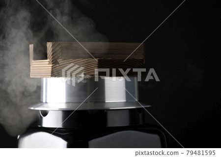 A picture of rice being cooked in a one-go cooking pot on a black background 79481595