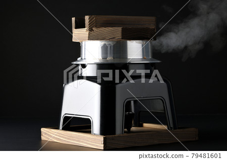 A picture of rice being cooked in a one-go cooking pot on a black background 79481601
