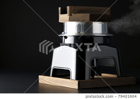 A picture of rice being cooked in a one-go cooking pot on a black background A picture of rice being cooked in a one-go cooking pot on a black background 79481604