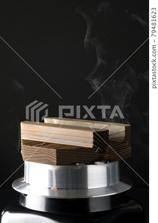 A picture of rice being cooked in a one-go cooking pot on a black background 79481623