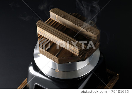 A picture of rice being cooked in a one-go cooking pot on a black background 79481625