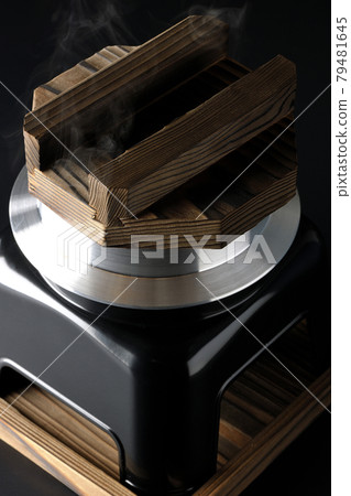 A picture of rice being cooked in a one-go cooking pot on a black background A picture of rice being cooked in a one-go cooking pot on a black background 79481645