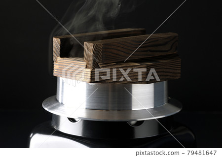 A picture of rice being cooked in a one-go cooking pot on a black background 79481647