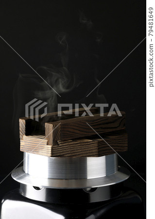 A picture of rice being cooked in a one-go cooking pot on a black background 79481649