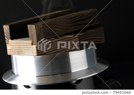 A picture of rice being cooked in a one-go cooking pot on a black background A picture of rice being cooked in a one-go cooking pot on a black background 79481660