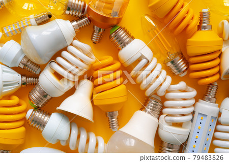 Light bulb on yellow paper background top view Light bulb on yellow paper background top view 79483826