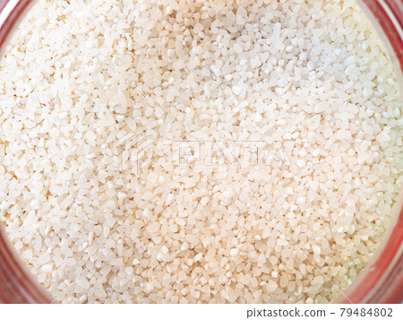 broken rice in pink glass jar 79484802