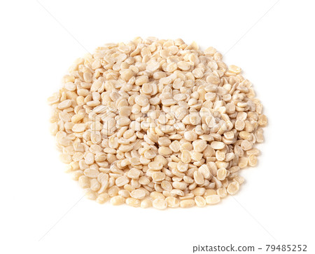 pile of raw split black gram beans on white pile of raw split black gram beans on white 79485252