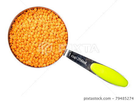 whole red lentils in measuring cup cutout 79485274