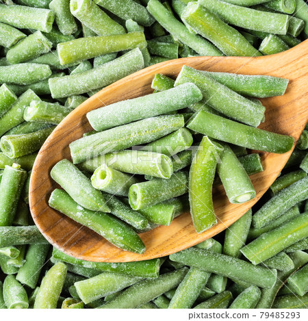 cut and frozen Green Beans in wooden spoon closeup cut and frozen Green Beans in wooden spoon closeup 79485293