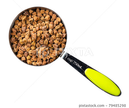 raw black chickpeas in measuring cup cutout 79485298