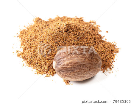 pile of whole nutmeg seed and powder on white 79485305